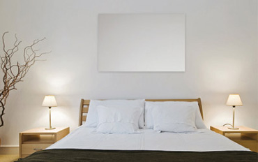 An infrared panel mounted on a bedroom wall