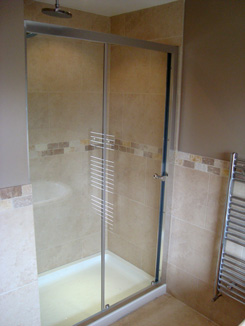 A finished shower cubicle with glass sliding door