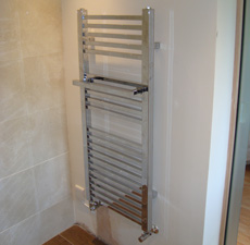 A heated towel rail installation in a bathroom